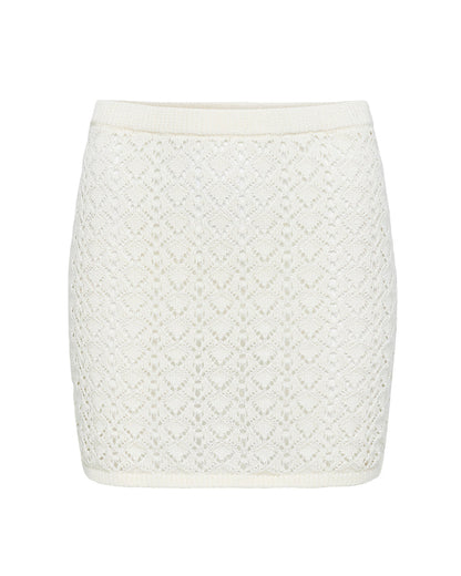 Off-model view of the LSPACE Nova Skirt in cream, displayed on a white background to show the cream crochet diamond pattern and ribbed waistband of the mini skirt.