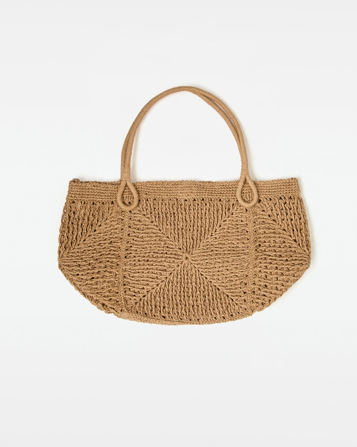 Off-model front view of the natural Paloma Beach Tote, a woven crochet bag with dual loop handles.