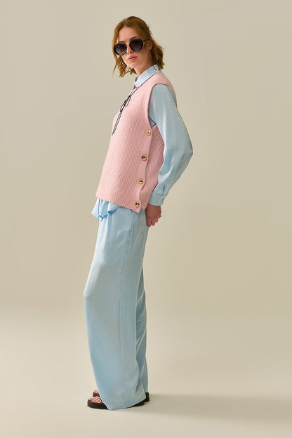 Pink sleeveless sweater with gold buttons