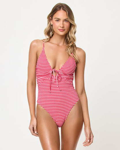 Front view of a model wearing the LSPACE lipstick red Piper One Piece Swimsuit in a red and white gingham print.