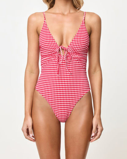 Close-up front view of a model wearing the LSPACE lipstick red Piper One Piece Swimsuit with keyhole tie detail.