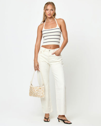 Front view of a model wearing the LSPACE Positano Top in mykonos stripe, a cropped halter top with a square neckline and cream and black horizontal stripes.