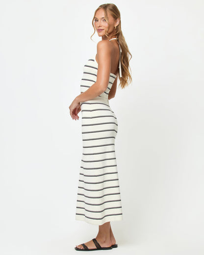 Side view of a model wearing the LSPACE Positano Top in mykonos stripe, showing the open-back halter design with cream and black horizontal stripes, styled with the matching Ravello Skirt.