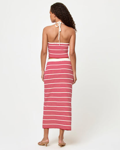 Back view of a model wearing the LSPACE Positano Top and Ravello Skirt in superbloom stripe, showing the ribbed fitted silhouette and red and cream horizontal stripe pattern.