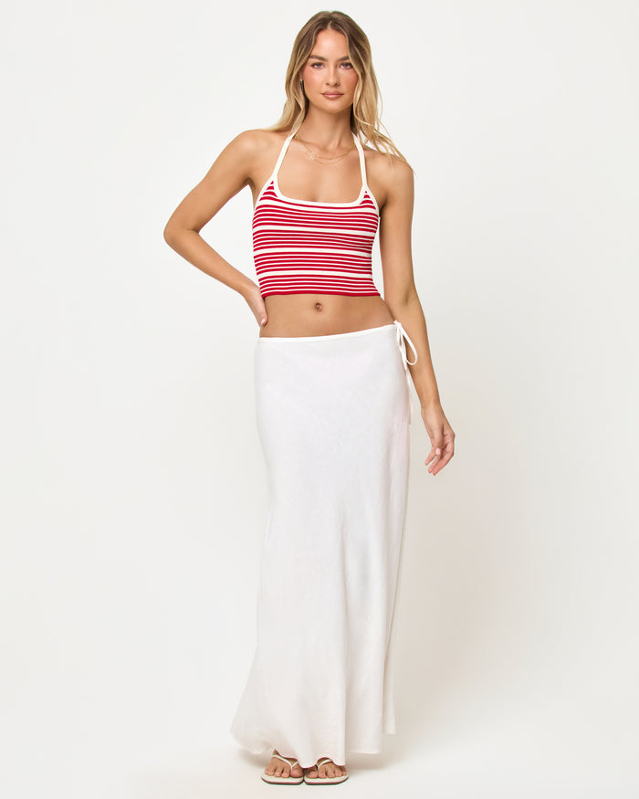 Front view of a model wearing the LSPACE Positano Top in superbloom stripe, a cropped halter top with a square neckline and red and cream horizontal stripes.