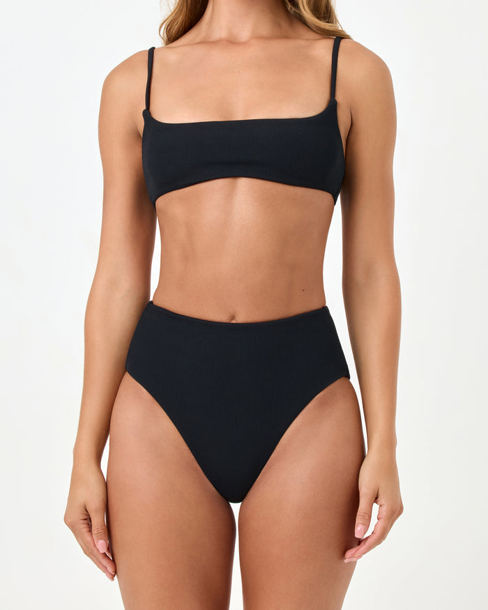 Close-up front view of a model wearing the LSPACE black Presley Bikini Top and the matching Soleil Bikini Bottom.