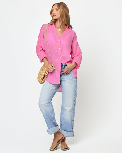 Front view of a model wearing the LSPACE Rio Tunic in hottest pink, an oversized linen button-up shirt with a relaxed fit and three-quarter sleeves.