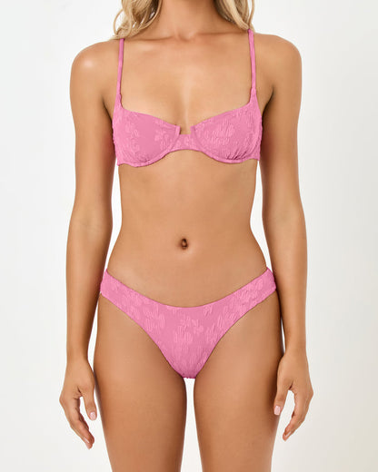 Close-up front view of a model wearing the LSPACE hottest pink Rocky Bikini Bottom with a tonal floral texture.