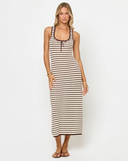 Front view of a model wearing the LSPACE Rosalie Maxi in cafe-cream, a fitted sleeveless knit maxi dress with cream and dark brown horizontal stripes and a scoop neckline with lace-up tie detail.
