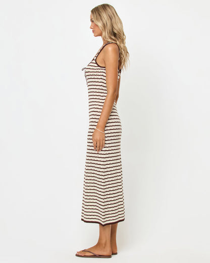 Side view of a model wearing the LSPACE Rosalie Maxi in cafe-cream, a fitted sleeveless knit maxi dress with cream and dark brown horizontal stripes, showing the slim silhouette and maxi length.