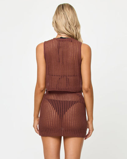 Back view of a model wearing the LSPACE Sander Skirt in cafe, showing the open crochet weave pattern of the mini skirt styled with the matching Sander Top.