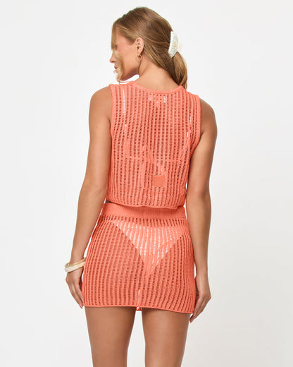 Back view of a model wearing the LSPACE Sander Skirt in fresh squeezed, showing the open crochet weave pattern of the mini skirt styled with the matching crop top.