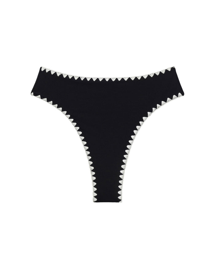 Off-model flat lay of the LSPACE Black-Cream Savannah Bikini Bottom on a white background, showing the black high-cut bottom with cream zigzag crochet trim along the waistband and leg openings.