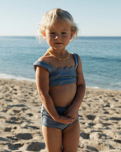 LSPACE Seashell Swirl set in chambray, lifestyle/editorial view on model at the beach.