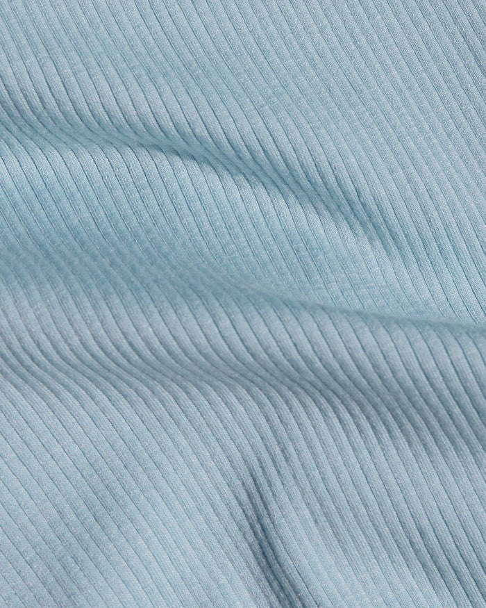 A close-up of light blue ribbed fabric.