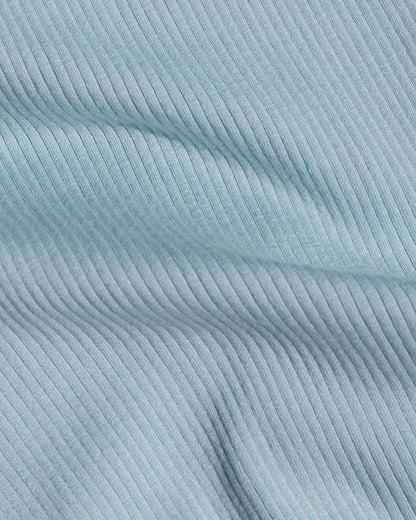 A close-up of light blue ribbed fabric.