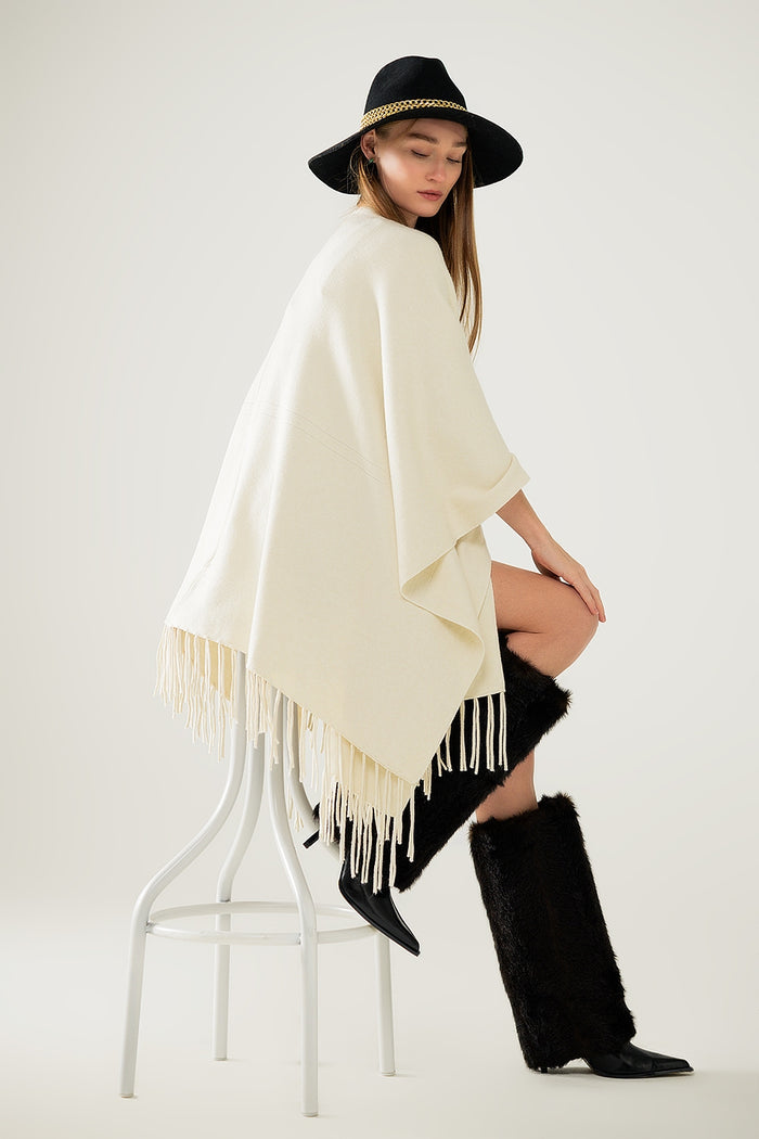Soft knitted poncho in beige with fringes