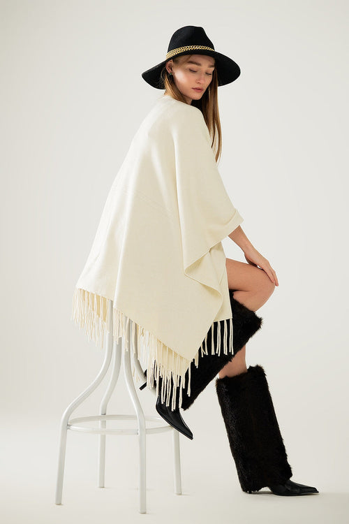 Soft knitted poncho in beige with fringes