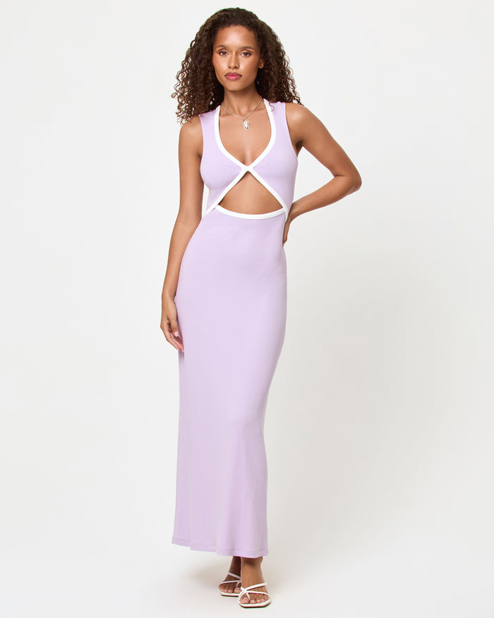 Front view of a model wearing the LSPACE Steph Dress in lilac-cream, a fitted maxi dress with a V-neckline, crossover front cut-out, and cream contrast trim.