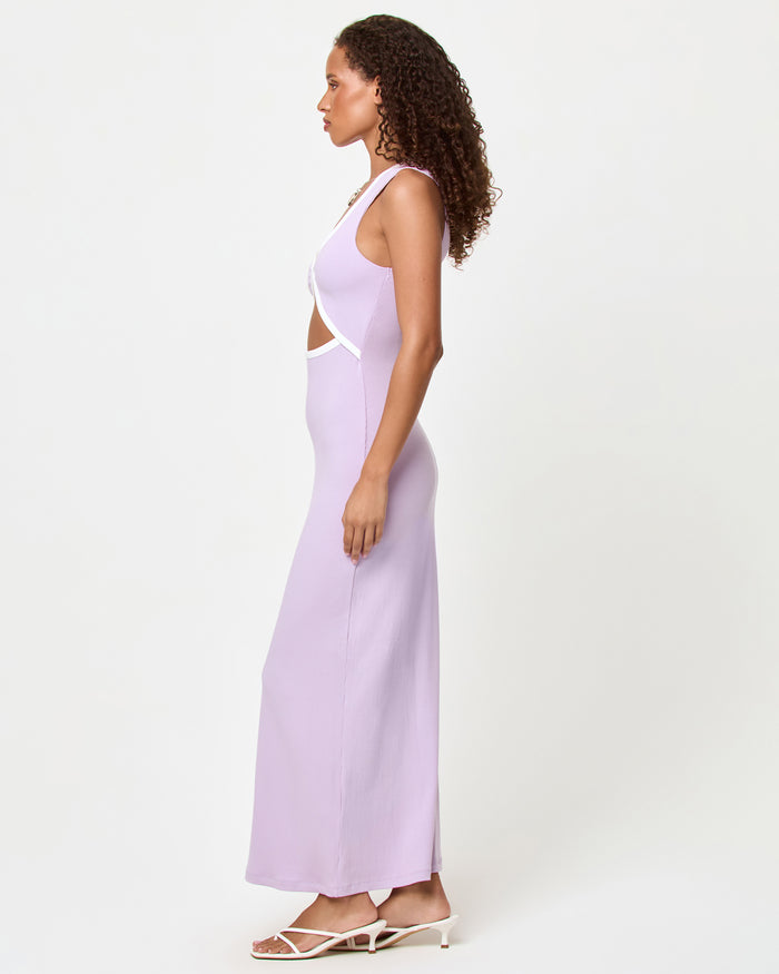 Side view of a model wearing the LSPACE Steph Dress in lilac-cream, showing the fitted silhouette and midriff cut-out detail of the maxi dress with cream contrast trim.