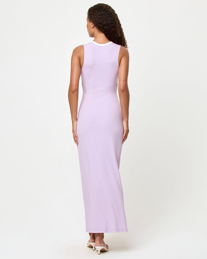 Back view of a model wearing the LSPACE Steph Dress in lilac-cream, showing the smooth back with cream contrast trim neckline of the fitted maxi dress.