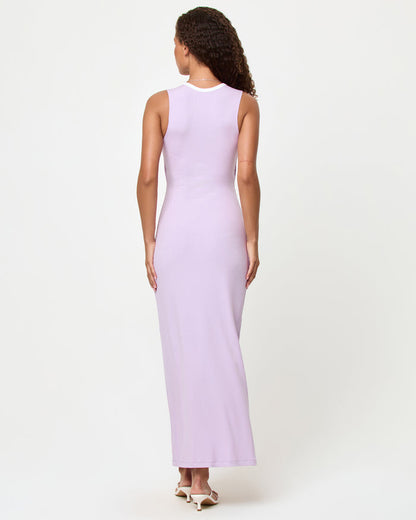 Back view of a model wearing the LSPACE Steph Dress in lilac-cream, showing the smooth back with cream contrast trim neckline of the fitted maxi dress.