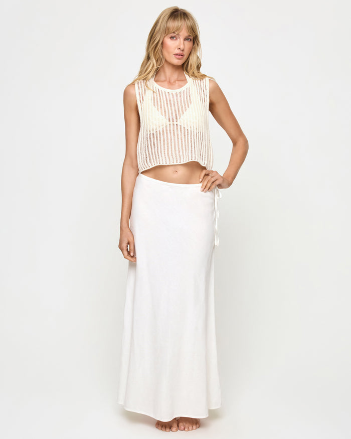 Front view of a model wearing the LSPACE Stop and Stare Skirt in cream, a flowing maxi skirt with a side tie closure, styled with the Sander Top in cream.