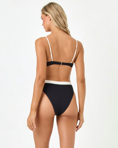 LSPACE Sunrise Shell bikini top in black-cream, back view on model.