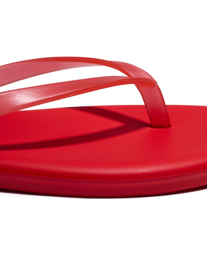 Close-up of the red thong strap and footbed detail on the TKEES Aqua Sandals.