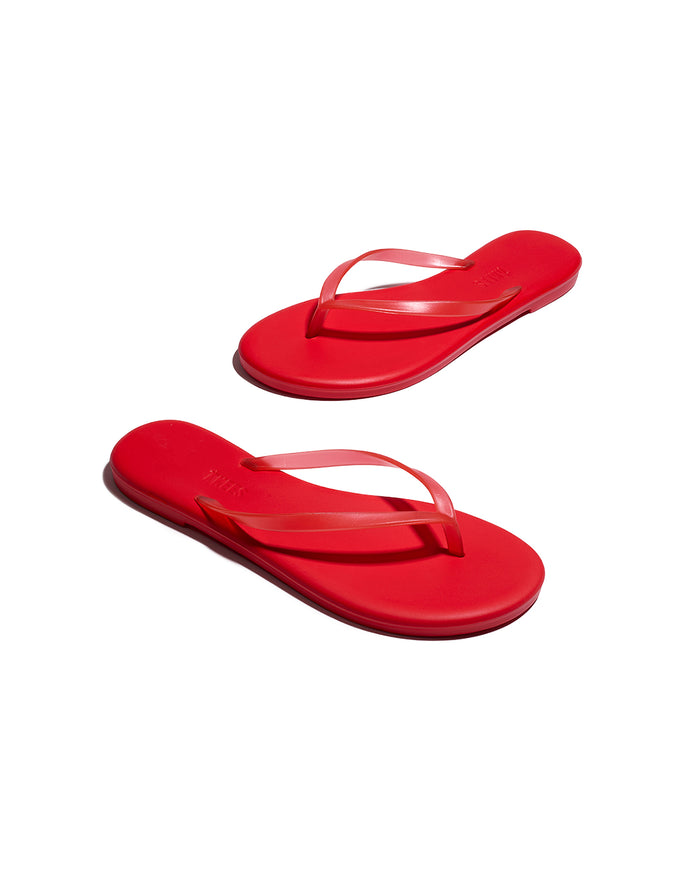 Angled view of both red TKEES Aqua Sandals showing the sole and side profile.
