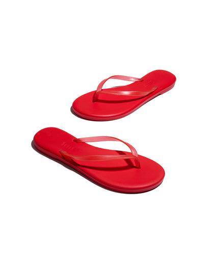 Angled view of both red TKEES Aqua Sandals showing the sole and side profile.