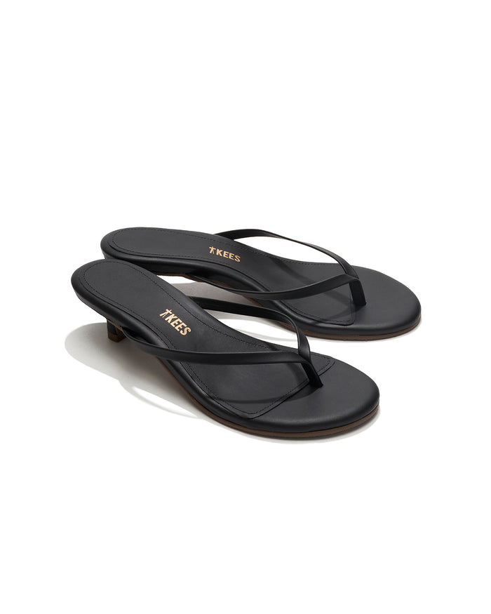Angled side view of a single black sable leather TKEES Julia Kitten Heel sandal showing the kitten heel.