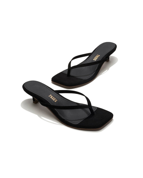 Angled view of both black suede TKEES Square Toe Julia sandals with gold TKEES logo on footbed.