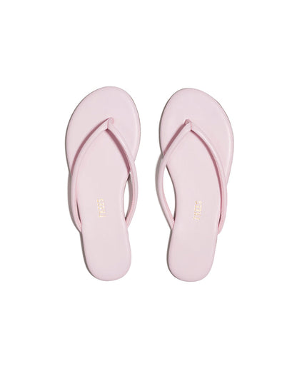 Top-down view of both powder pink TKEES Tubular Lily flip flops with TKEES logo on footbed.