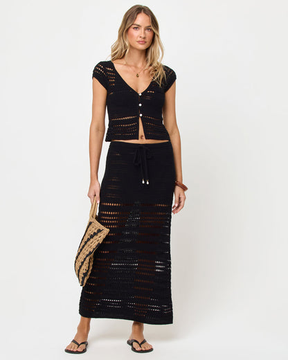 Front view of model wearing the LSPACE Tula Skirt in black, a semi-sheer crochet maxi skirt with drawstring waist, styled with a matching black crochet top.