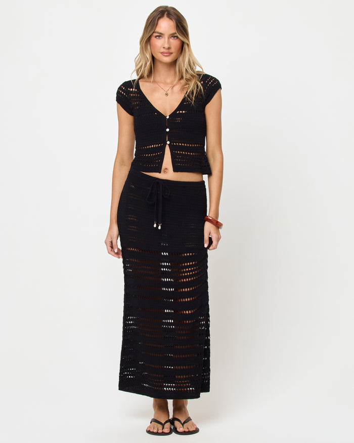 Front view of the LSPACE Tula Top in black showing the crochet open-stitch texture and button front detail.
