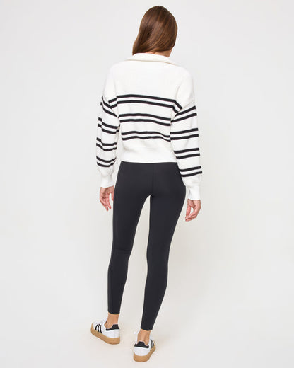 Back view of the LSPACE Ultra Stripe Sweater in black-white on a model, showing the back of the ribbed sweater with bold black and white horizontal stripes.