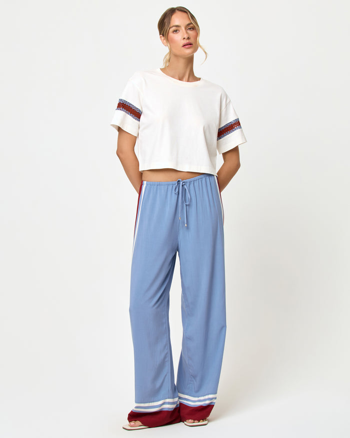 Front view of model wearing the LSPACE Unwind Pant in unwind stripe, a relaxed wide-leg striped pant with drawstring waist.