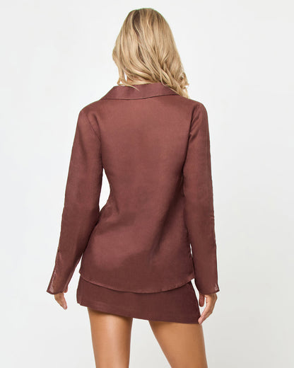 Back view of a model wearing the LSPACE Venice Skort in cafe, showing the linen A-line mini silhouette, styled with the matching Venice Shirt in cafe.