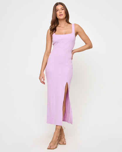 Front view of a model wearing the LSPACE Vivienne Dress in light iris, a fitted midi dress with a square neckline, sleeveless silhouette, and side slit hem.