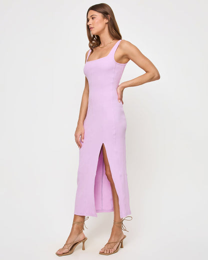 Side view of a model wearing the LSPACE Vivienne Dress in light iris, highlighting the fitted silhouette and side slit at the hem.