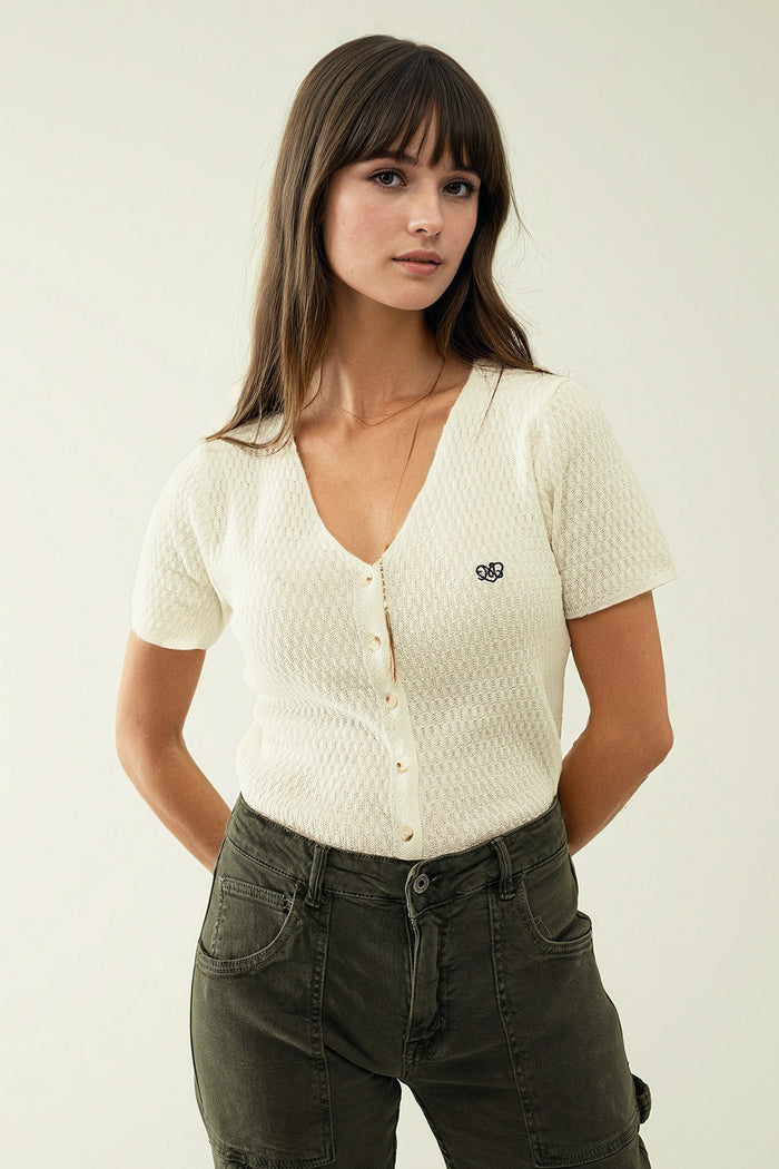 White cardigan with short sleeves and front closure with button