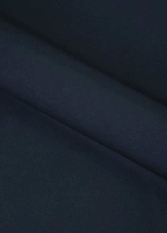 Dark black wash-and-wear fabric close-up with smooth drape