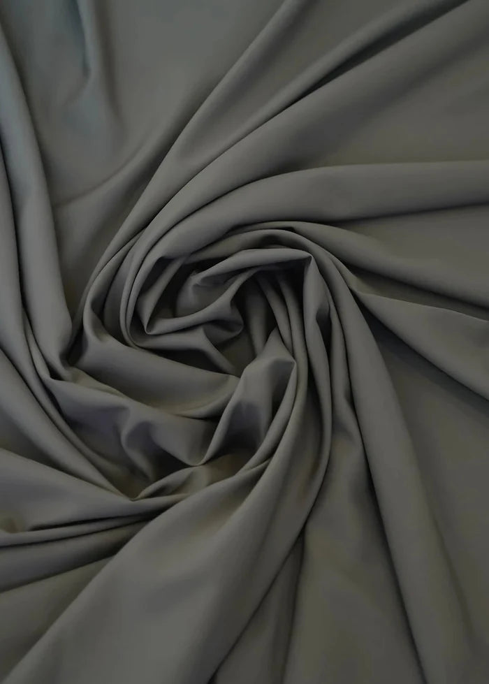 Charcoal wash-and-wear winter fabric gathered in soft folds