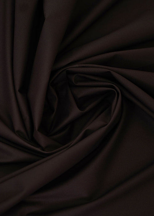 Dark chocolate-brown dobby fabric with raised geometric texture, close-up