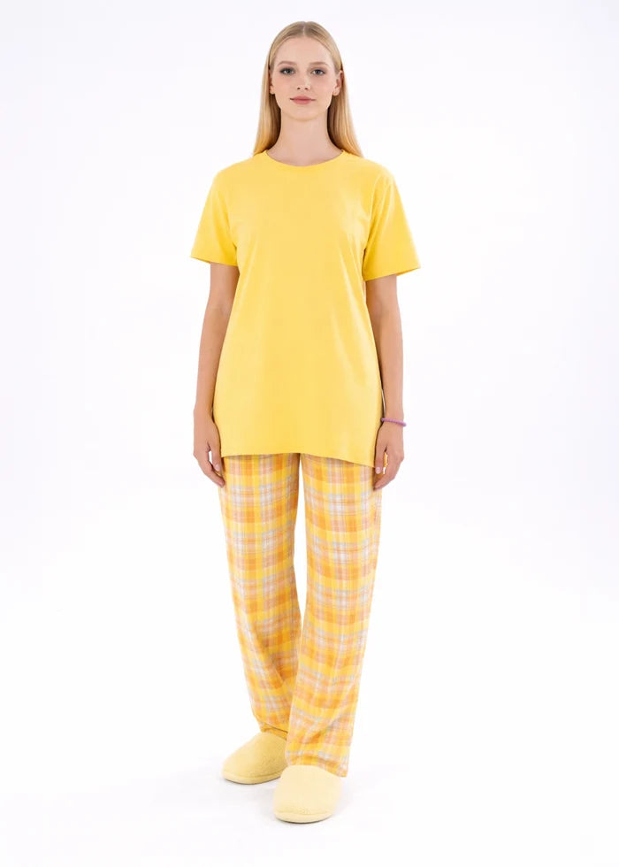 Yellow night shirt with short sleeves and crew neck, paired with plaid pajama trousers