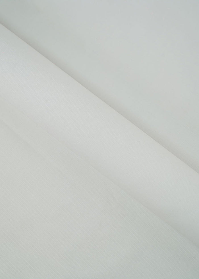 Off-white dobby fabric panel with subtle geometric weave, draped diagonally