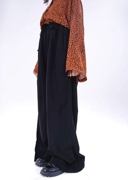 Women's winter pull-on black trousers, side view with relaxed wide-leg fit