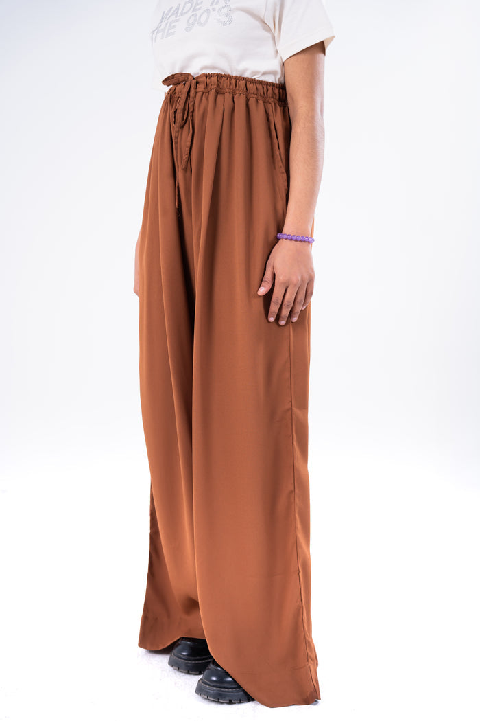 Brown wide-leg pull-on trousers with gathered elastic waist and tie front