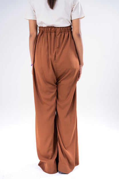 Brown pull-on wide-leg trousers with elastic waist and relaxed draped fit
